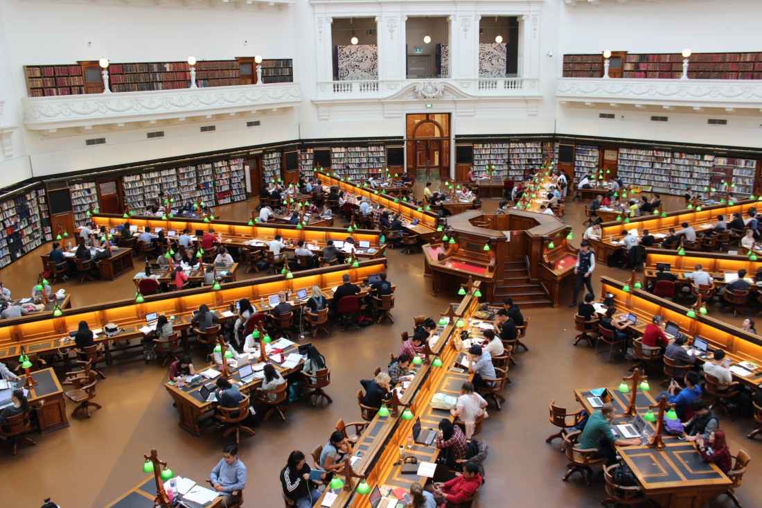 people sitting on desks inside well lit room